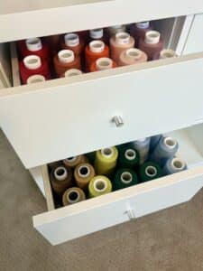 Serger thread cones organized into rainbow order and put into 2 pulluot drawers.