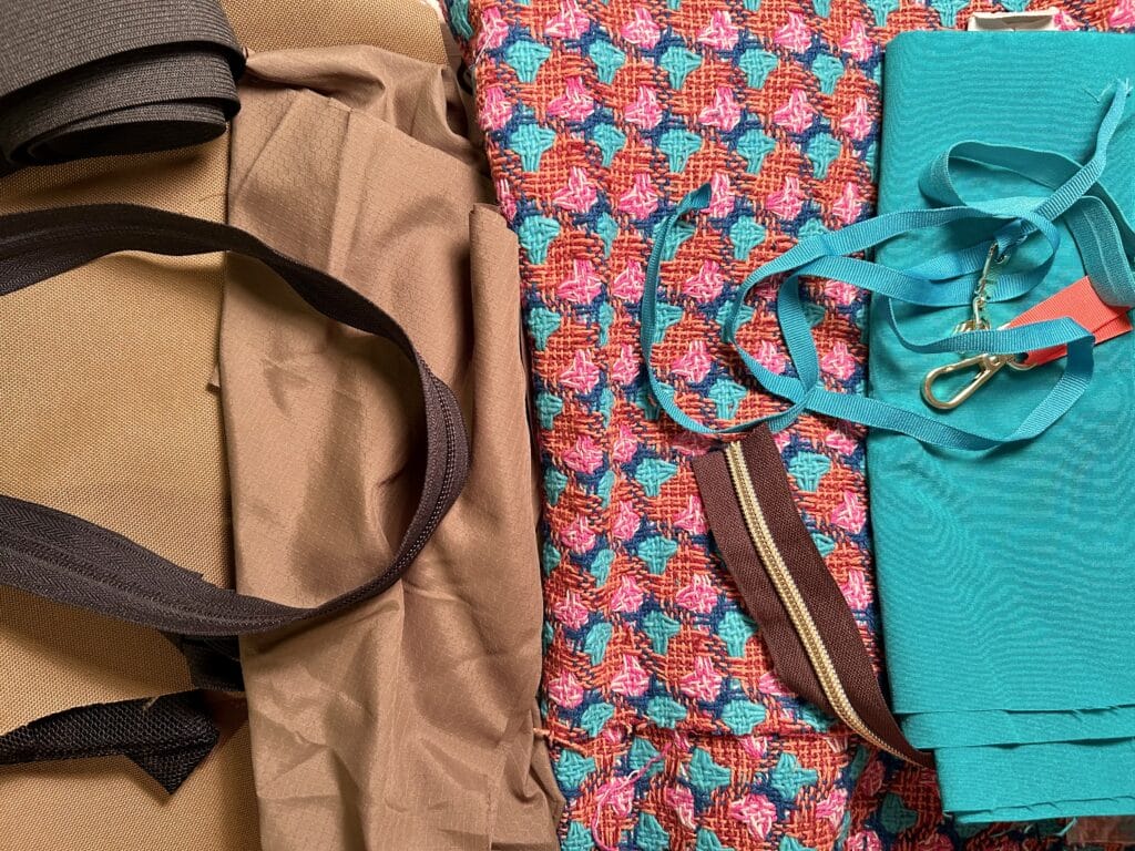 Tan outdoor fabric and black trim on the left; orange and pink tweed fabricand satin lining on the right. 