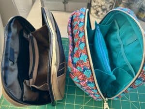 The two pouches opened up and showing their interiors with pockets and a pen loop.