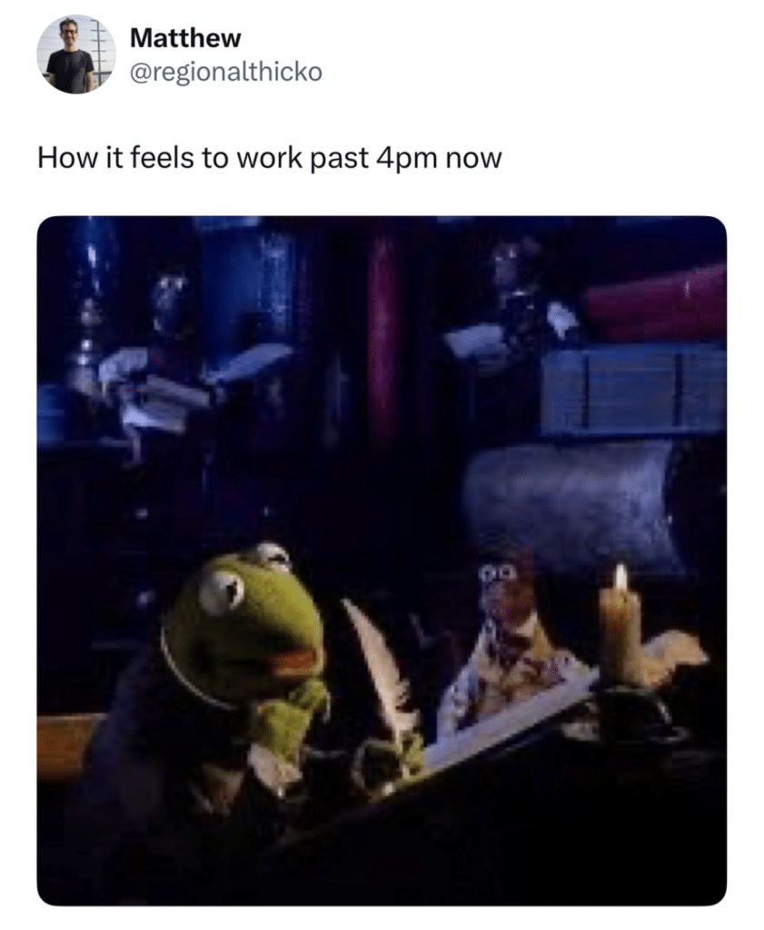 A screenshot of the Muppet Christmas Carol movie where Kermit as Bob Cratchit works in Scrooge's office by the light of a single candle. Text reads How it feels to work past 4pm now