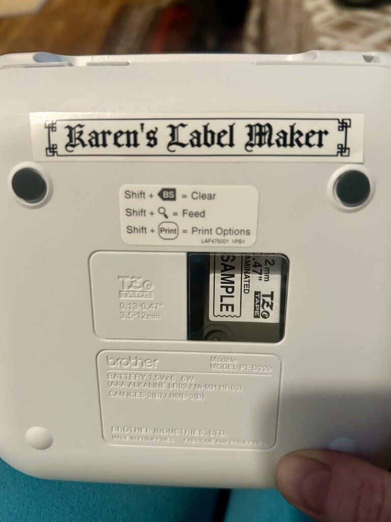 The back of a label maker labeled "Karen's Label Maker" in gothic font