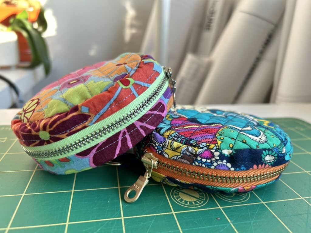 Two round small cases on top of each other, in bright colors.