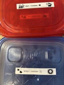 Two leftover containers labeled, "Alan's container" and "Mike's container"