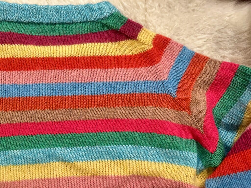 Detail of the shoulder shaping on the back of a striped sweater 