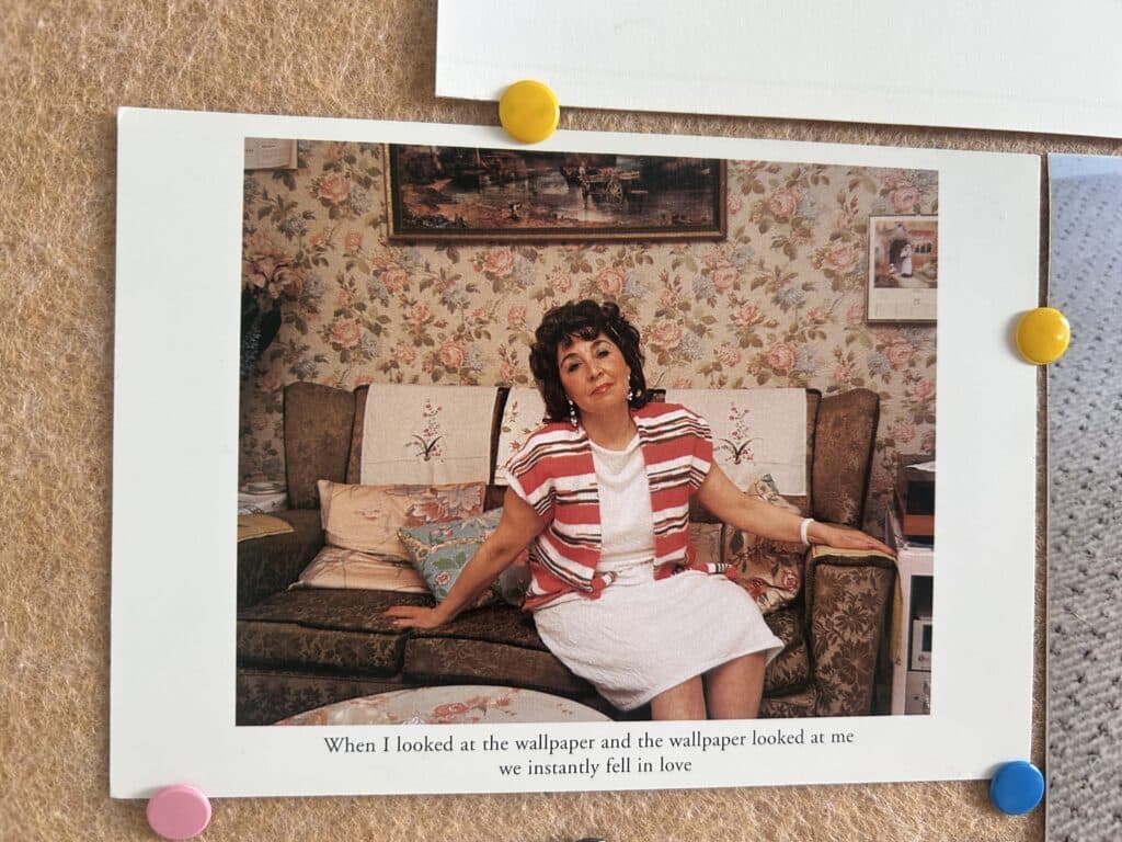 A vintage 80s photo of a woman on a patterned couch with wallpaper behind her. Text below the photo says, "When I looked at the wallpaper and the wallpaper looked at me we instantly fell in love"