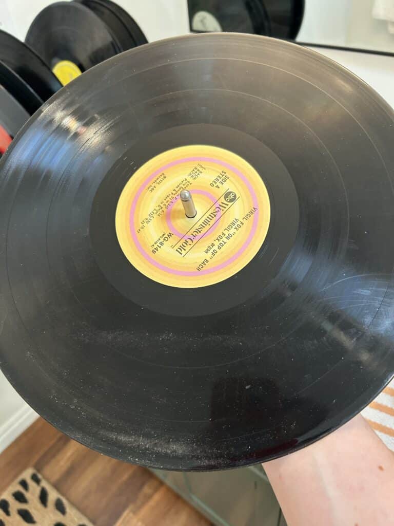 A vinyl record covered in dust and fingerprints