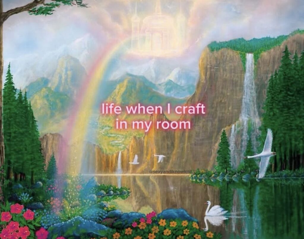Fantasy painting of a waterfall and a pond with swans on it, surrounded by flowers with a rainbow in the sky. Text reads, life when I craft in my room