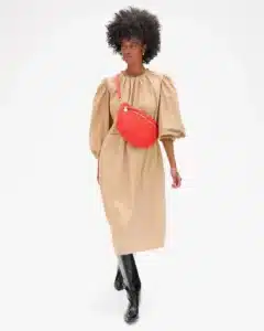 Screengrab of the Calre V site showing a model wearing a poppy red crossbody pouch