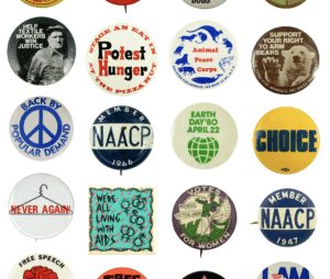 an evenly spaced grid of different colorful pinback buttons with protest slogans