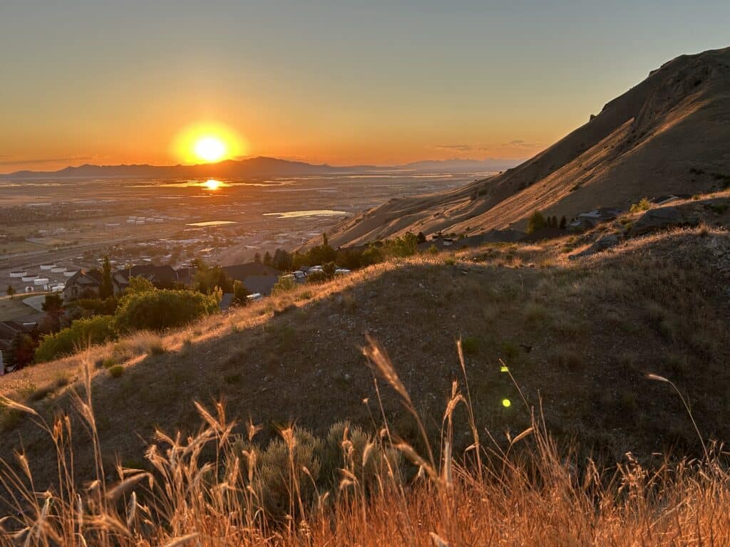 Sunset over mountains, as seen from foothills above a city