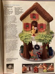A tiered cake that looks like a treehouse, with Sesame Street characters