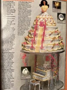 Page from a Wilton book showing an elaborate tiered cake in the shape of a dress, with a doll on the top and a piano underneath