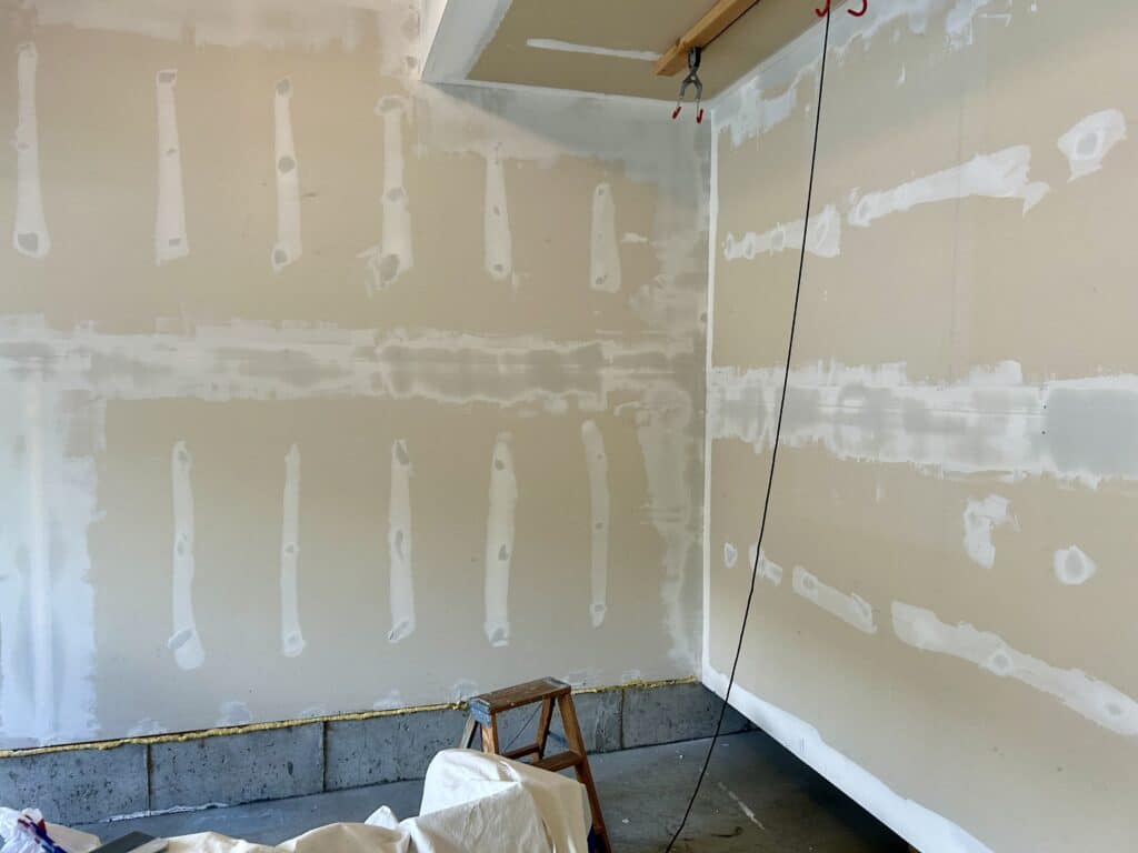Wet mud on all the drywall seams in a long garage wall 