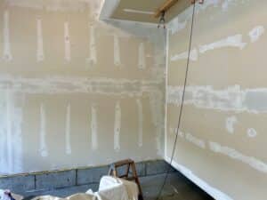 Wet mud on all the drywall seams in a long garage wall