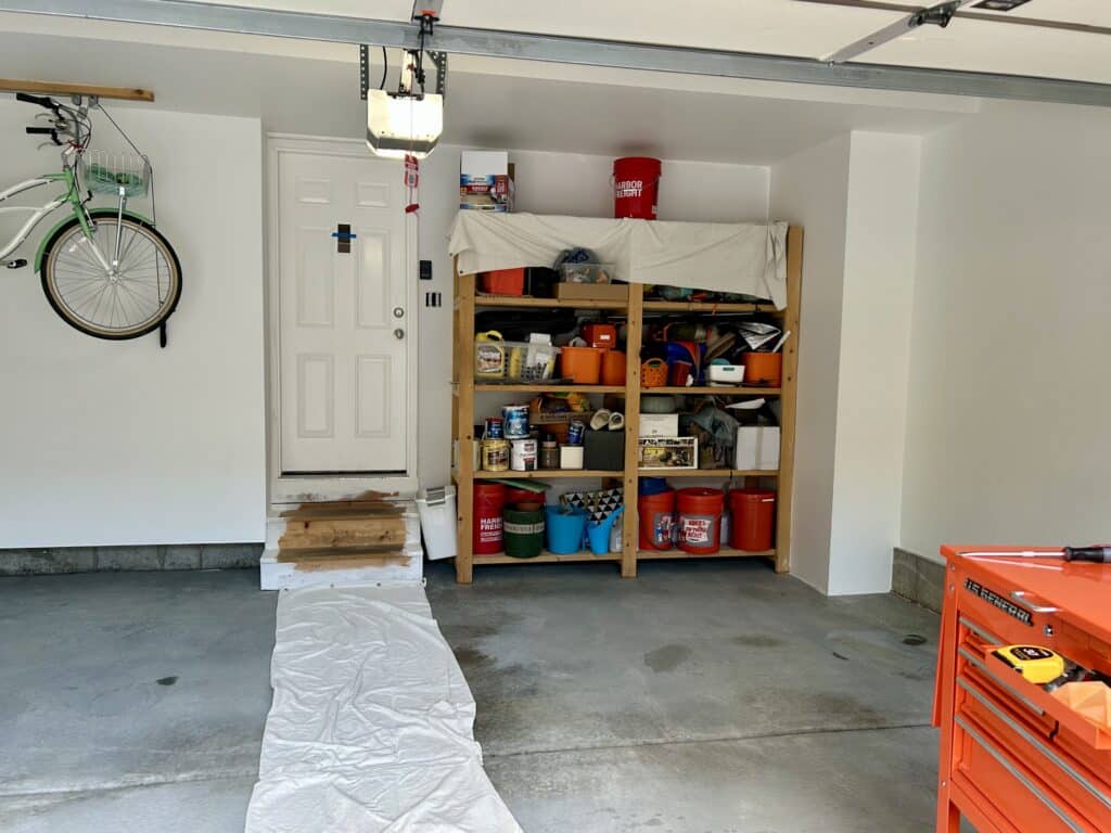 An empty garage with built in shelving. The walls are freshly painted white.