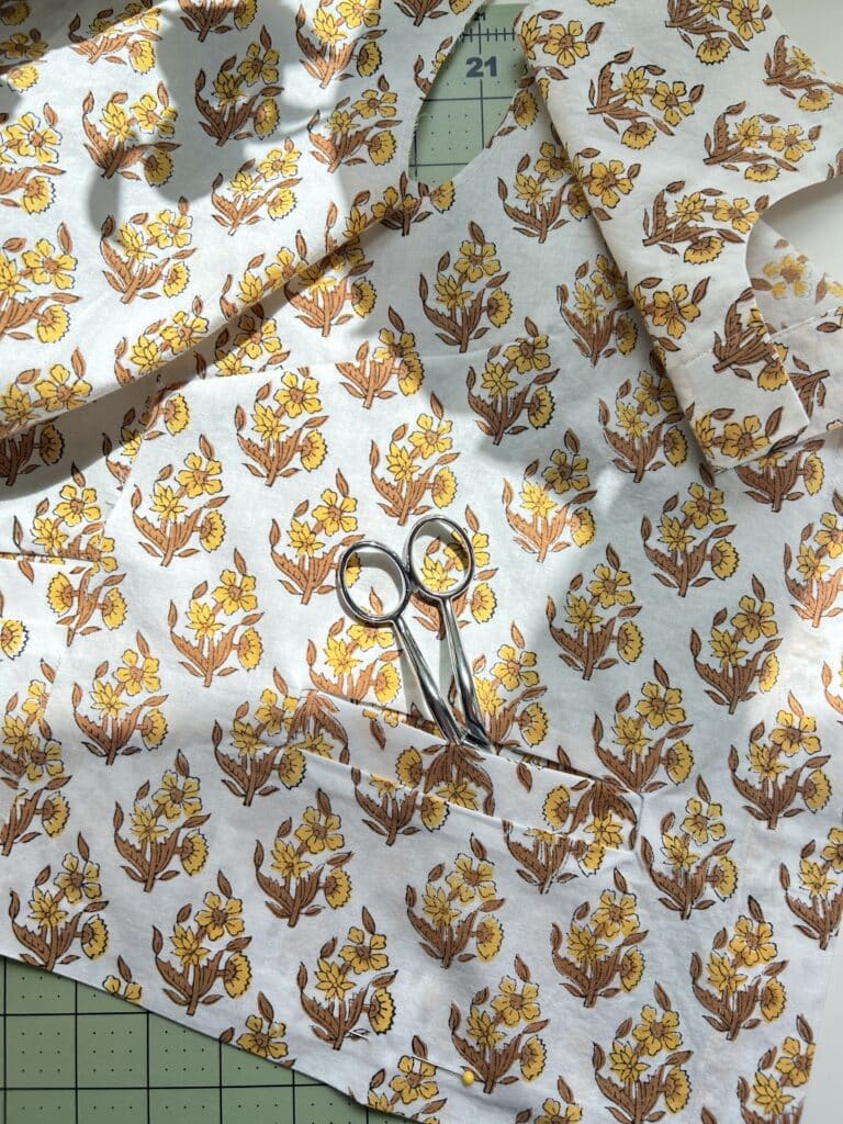 A welt pocket in a yellow-on-white block print shirt