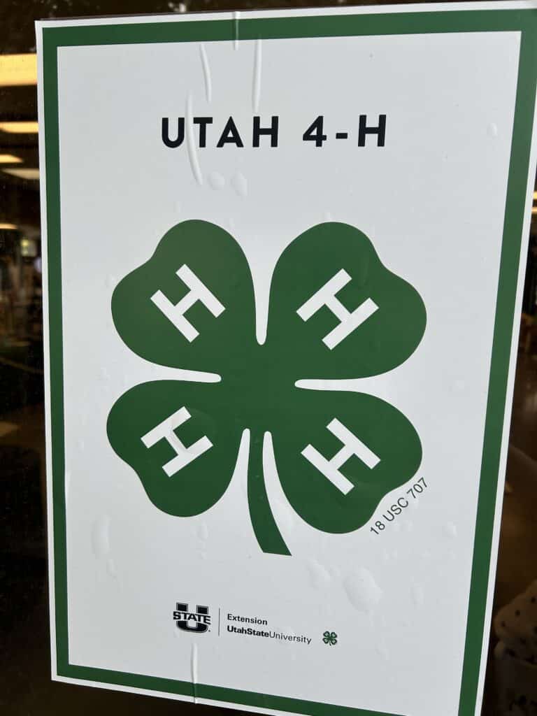 A sign with the 4-H logo of a green clover